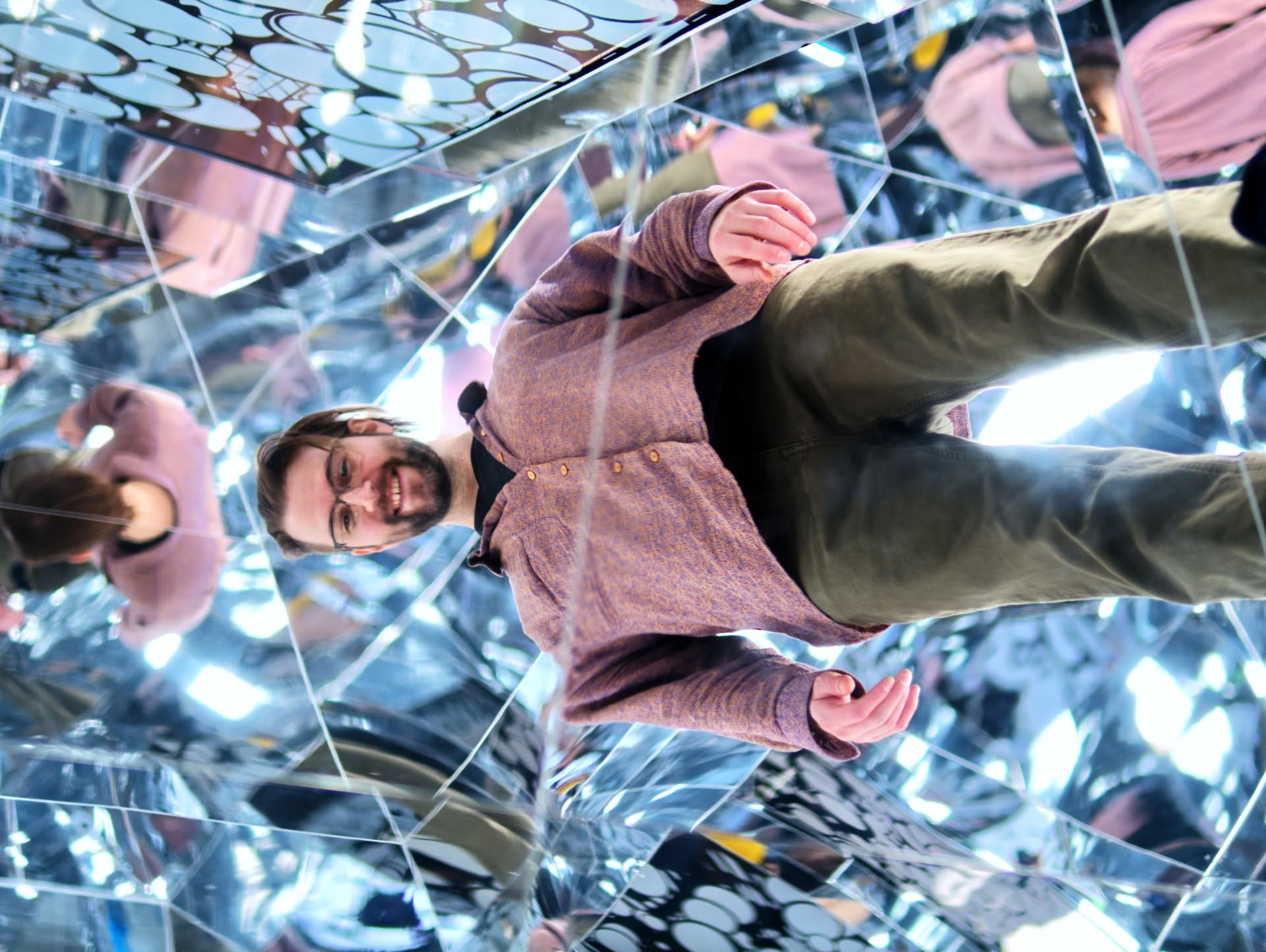 Paul M. Christian inside a mirrored light installation